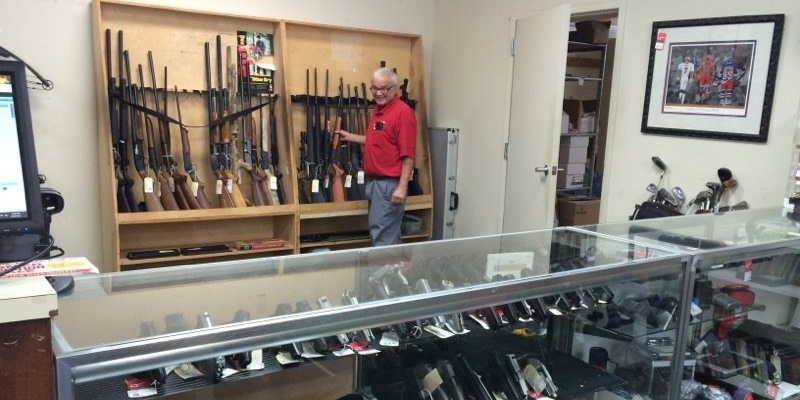 Quik-Pawn-employee-at-gun-counter-979030-edited.jpg